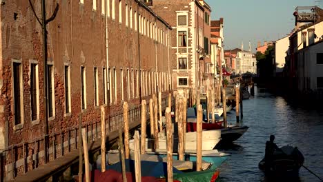 Man-Rowing-Boat-In-Venice-Canal-At-Dawn-Or-Dusk