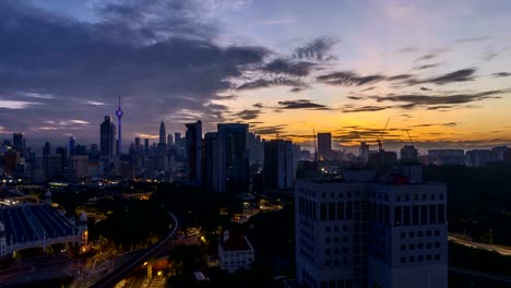 dramatic-sunrise-at-Kuala-Lumpur-city-with-sun-burst-ray.-Moving-and-changing-color-clouds.