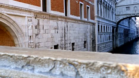 Canal-between-old-buildings-in-Venice,-Italy