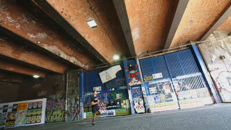 A-man-running-under-a-bridge-in-inner-London.