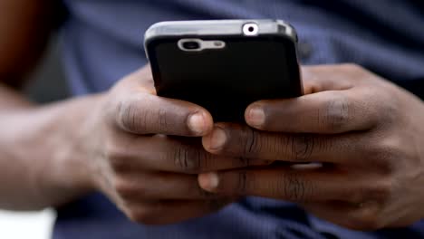 youth,technology,-communication.black-african-man's-hands-typing-on-smartphone
