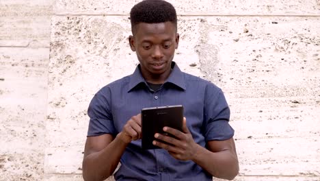 Attractive-african-american-man-using-digital-tablet--outdoor