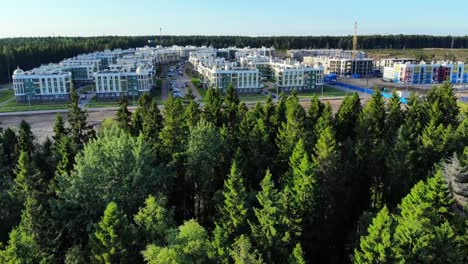 Aerial-panorama-of-forest-and-small-town,-apartment-houses