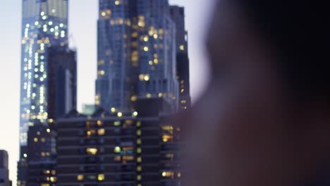 Close-up-of-woman's-profile-with-Manhattan,-NY-in-the-background