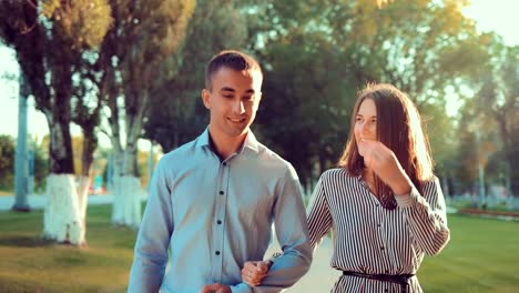 Young-happy-couple-walking-in-beautiful-summer-park