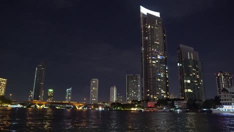 Corporate-buildings-with-offices-on-the-river-bank-at-night.-light-from-the-windows-of-offices.-business-center