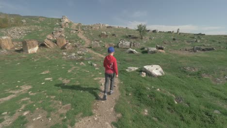 Boy-walking-to-the-ancient-ruins-in-Pamukkale,-Turkey