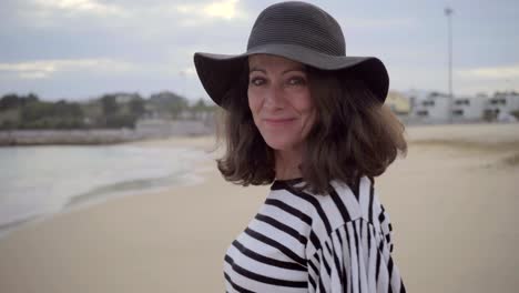 Attractive-positive-mature-lady-in-grey-hat-looking-at-camera.