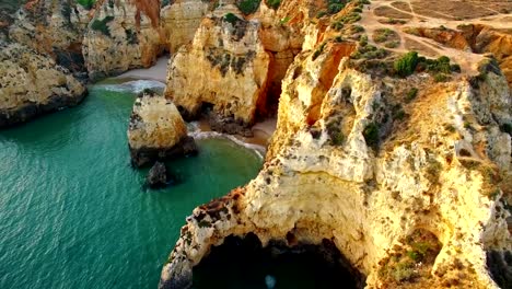 Ponta-da-Piedade-on-cliff-near-ocean-at-sunset,-Lagos,-aerial-view