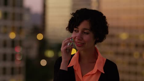 Woman-talking-on-phone-at-night-in-city