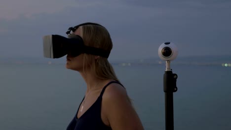 Woman-in-VR-headset-and-360-degree-camera