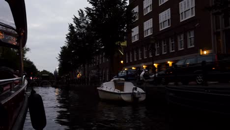 Cruising-an-Amsterdam-Canal-at-Dusk-and-Looking-at-the-City-Architecture