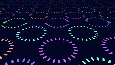 Neon-rainbow-circles-pattern-in-rows-on-black-gradient