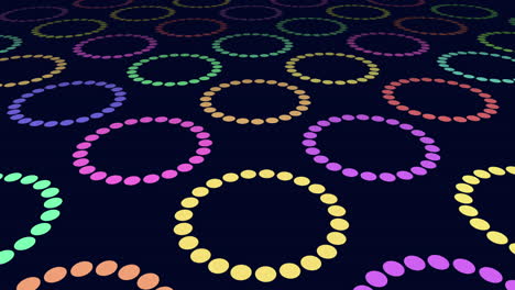 Neon-rainbow-circles-pattern-in-rows-on-black-gradient