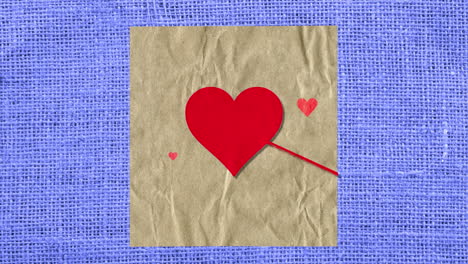 Red-hearts-with-arrow-on-paper-with-textile