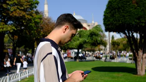 Young-man-phone-front-Hagia-Sophia