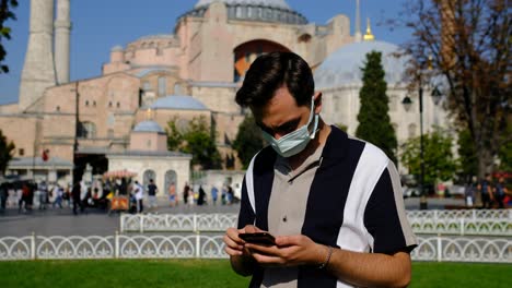 Young-man-mask-phone-front-Hagia-Sophia