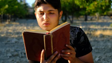 Teenager-reading-quran-in-garden