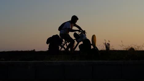 Junger-Mann-Reitet-Fahrrad-Bei-Sonnenuntergang