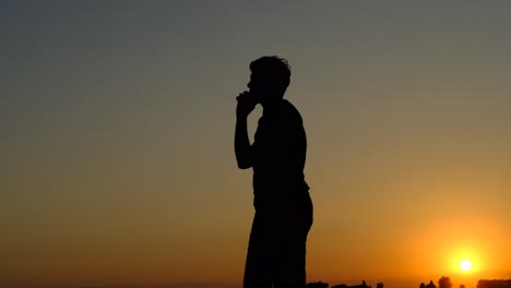 Teenager-silhouette-talking-by-phone