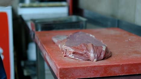 Cutting-raw-steak