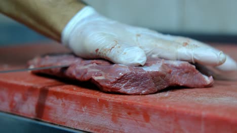 Chef-cuts-raw-meat