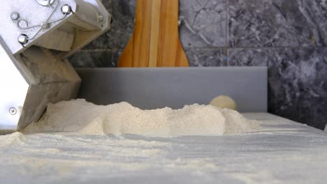 Phyllo-bread,-hands-making-phyllo-bread-dough-maker-close-up