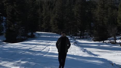 Young-Man-Strolling-in-Snowy-Forest