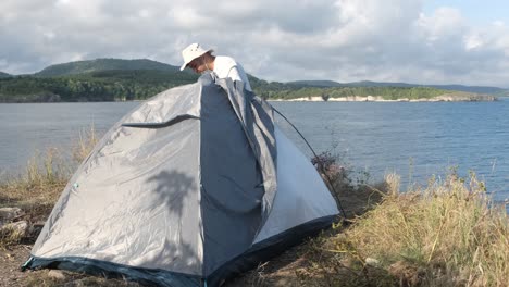 Camper-man-dismantling-tent
