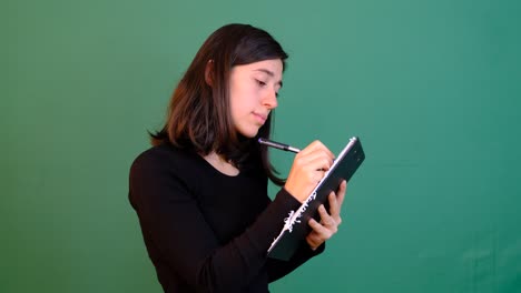 Woman-Writing-Green-Background