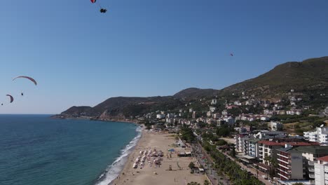 Paragliders-Descending-Towards-The-Beach