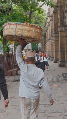 Vertical-Video-Of-People-Walking-By-CSMT-Railway-Station-In-Mumbai-India