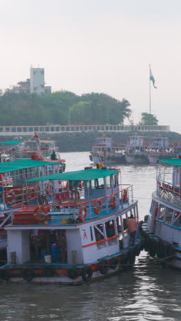 Vertical-Video-Of-Ferry-Boats-Docked-By-The-Gateway-Of-India-In-Mumbai