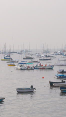 Vertical-Video-Of-Boats-And-Yachts-Moored-By-The-Gateway-Of-India-And-Taj-Palace-Hotel-In-Mumbai