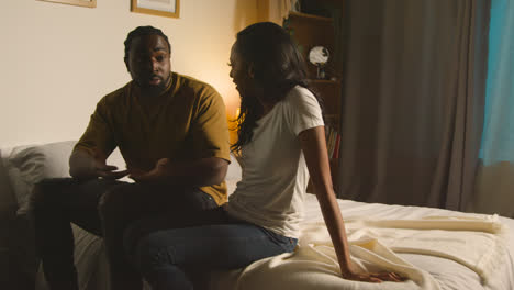 Couple-At-Home-Sitting-On-Bed-At-Night-Having-Argument-1