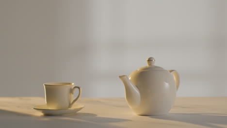 Studio-Shot-Of-Making-Traditional-British-Cup-Of-Tea-Using-Teapot