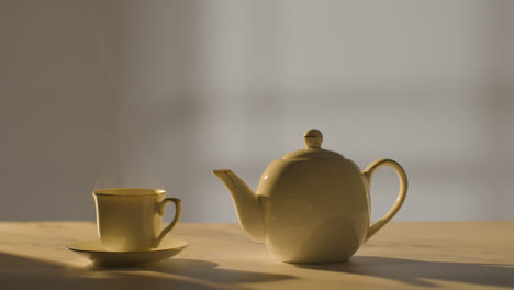 Studio-Shot-Of-Making-Traditional-British-Cup-Of-Tea-Using-Teapot-4