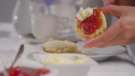 Close-Up-Shot-Of-Person-With-Traditional-British-Afternoon-Tea-With-Scones-Cream-And-Jam-6