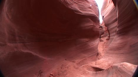 POV-walking-through-a-narrow-passage-between-rock-formations-in-Canyonlands-National-Park