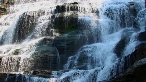 A-wide-waterfall-flows-over-rock-ledges-in-Ithaca-Falls-New-York-4