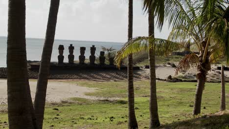 Easter-Island-statues-stand-in-a-long-row-on-a-distant-beach