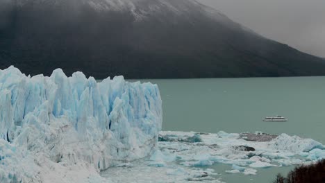 A-boat-sits-near-the-side-of-a-giant-glacier-in-Patagonia-Argentina