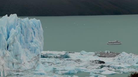 A-boat-sits-near-the-side-of-a-giant-glacier-in-Patagonia-Argentina-1