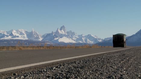 A-truck-passes-on-a-remote-highway-in-Southern-Argentina-with-the-Fitzroy-mountain-range-in-background-Patagonia