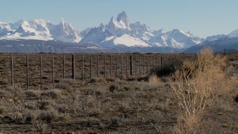 Pan-across-a-fenced-region-in-the-far-Southern-region-of-Patagonia-with-the-Fitzroy-Range-in-background