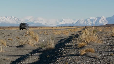 A-car-on-a-remote-road-heading-into-the-Andes-mountains-in-Patagonia-Argentina-1