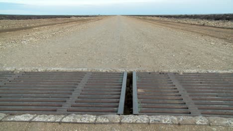 A-steel-metal-grate-cattle-guard-on-a-lonely-road