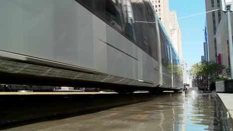A-rapid-transit-train-moves-quickly-through-downtown-Houston-with-fountains-dancing-2