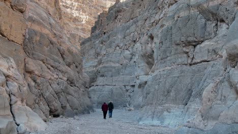 A-senior-man-and-woman-hike-in-a-canyon-in-Death-Valley-1