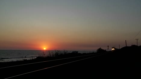 Beautiful-shot-of-an-Amtrak-train-passing-by-a-California-beach-at-sunset-1